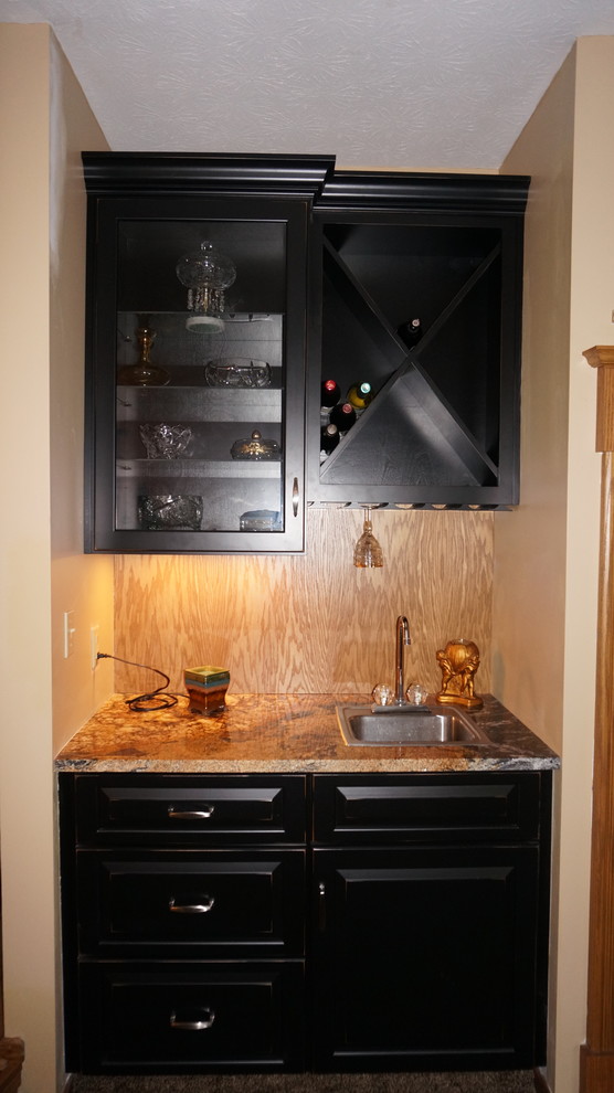 This is an example of a large rustic l-shaped home bar in Cleveland with a submerged sink, recessed-panel cabinets, medium wood cabinets, granite worktops and medium hardwood flooring.