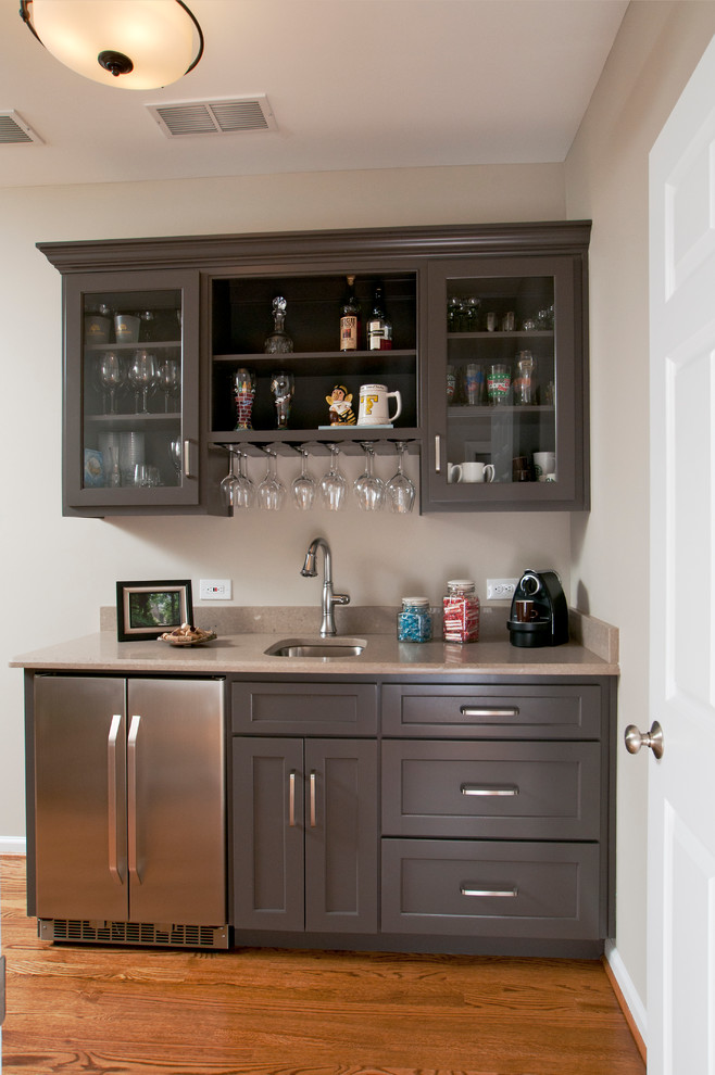 Design ideas for a small traditional single-wall wet bar in Atlanta with a submerged sink, recessed-panel cabinets, grey cabinets, marble worktops and medium hardwood flooring.