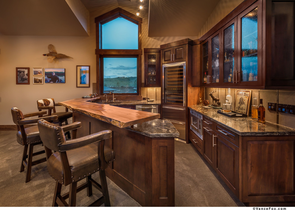 This is an example of a large rustic home bar in Other.