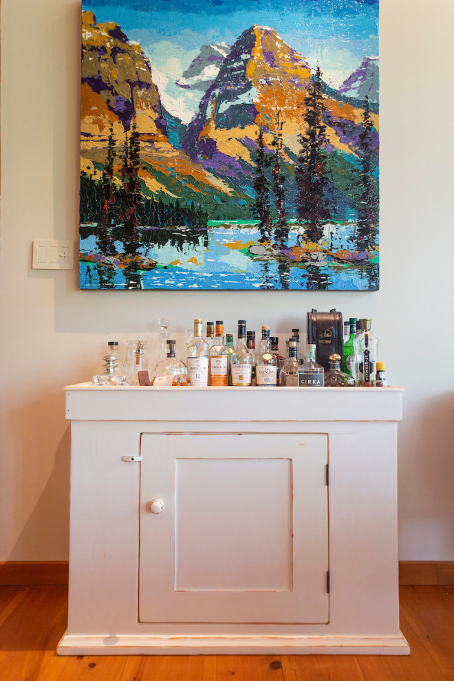 Small mountain style single-wall medium tone wood floor and orange floor bar cart photo in Montreal with white cabinets, wood countertops and white countertops