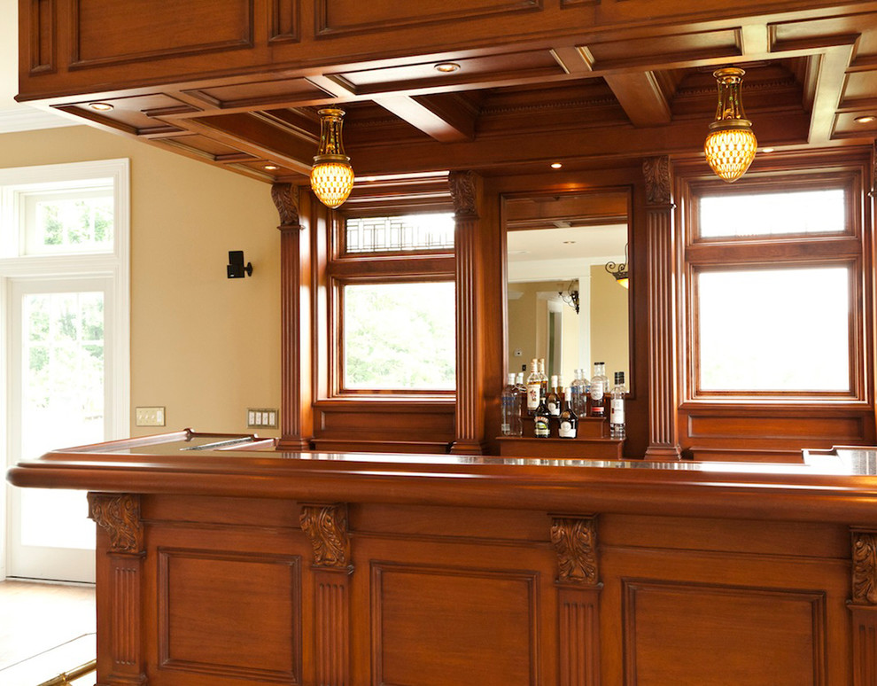 This is an example of a medium sized traditional home bar in New York with ceramic flooring.