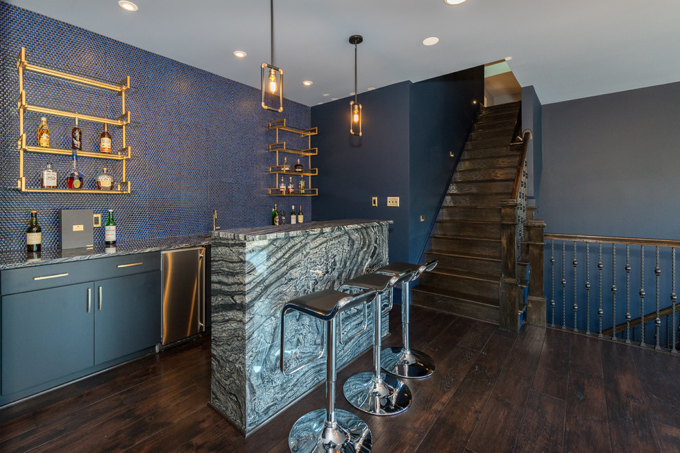 Seated home bar - traditional single-wall dark wood floor and brown floor seated home bar idea in Richmond with flat-panel cabinets, gray cabinets, blue backsplash and multicolored countertops