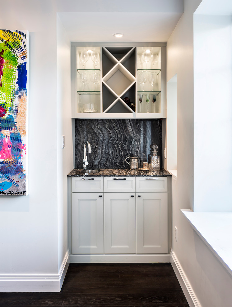 Design ideas for a small traditional single-wall wet bar in New York with shaker cabinets, white cabinets, dark hardwood flooring, a submerged sink, granite worktops, black splashback and stone slab splashback.