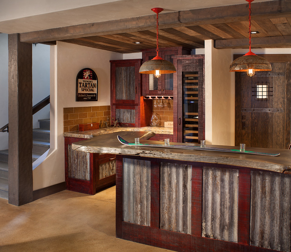 Inspiration for a rustic home bar in Seattle with distressed cabinets, brown splashback, metro tiled splashback and concrete flooring.