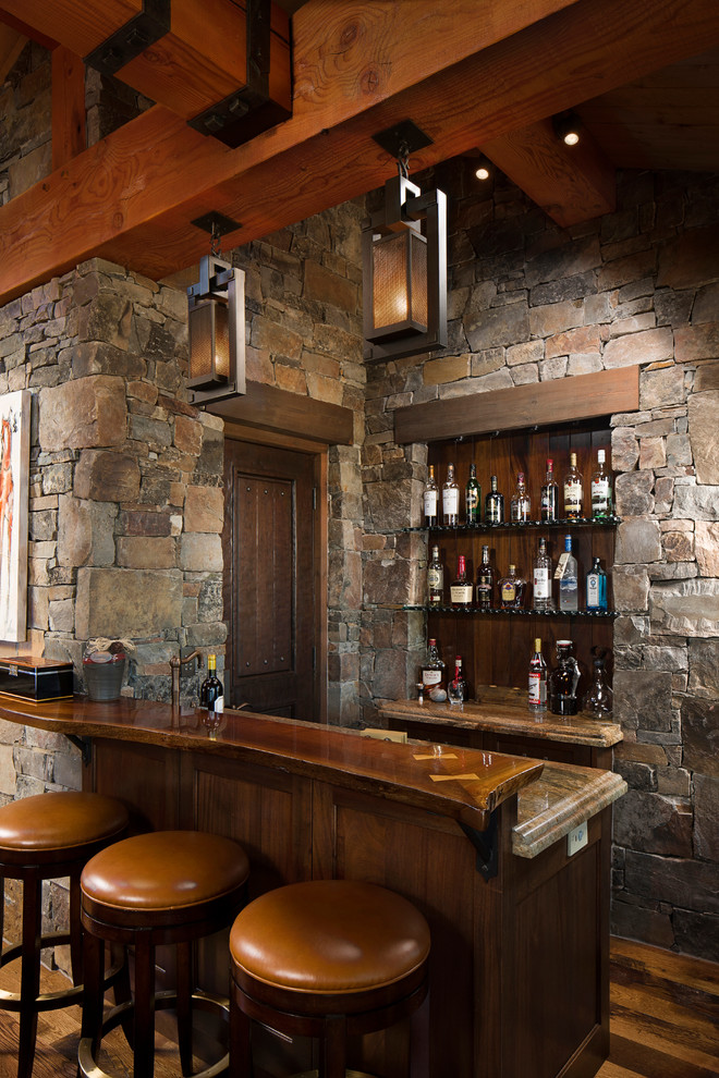 Seated home bar - small rustic galley dark wood floor and brown floor seated home bar idea in Other with dark wood cabinets, raised-panel cabinets, granite countertops, multicolored backsplash and stone tile backsplash