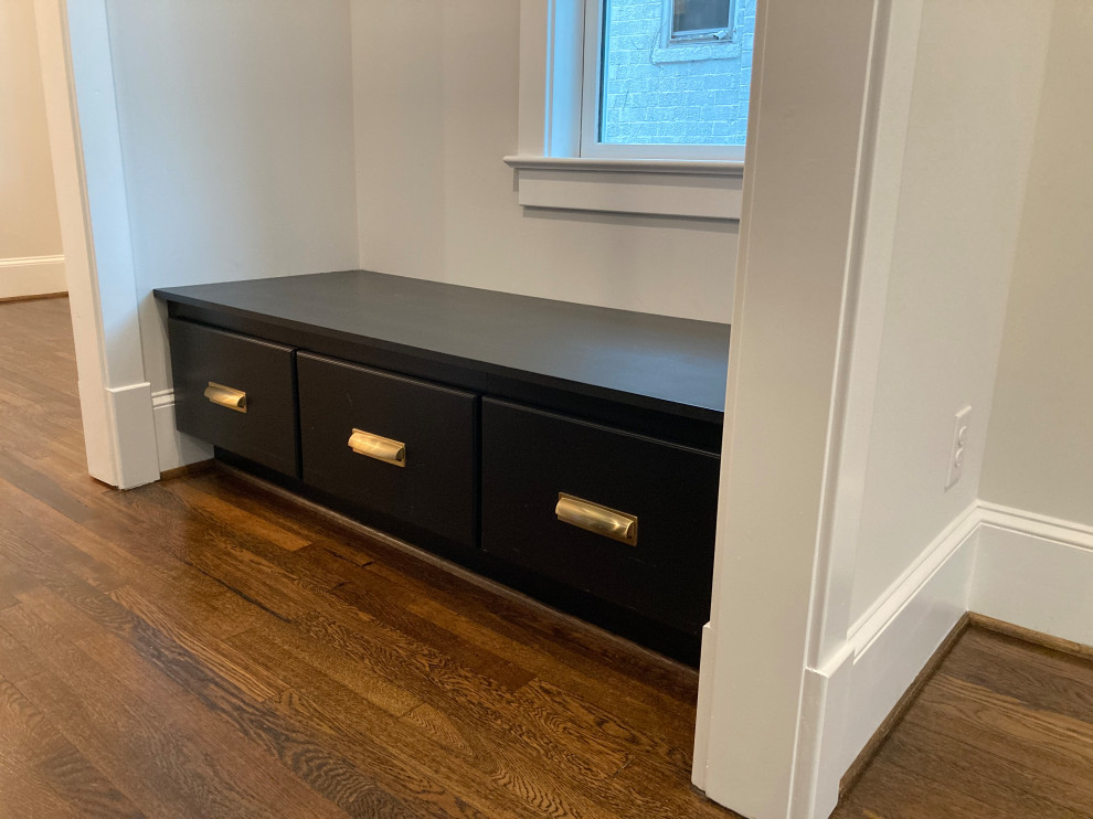 Photo of a medium sized traditional galley wet bar in DC Metro with shaker cabinets, black cabinets and dark hardwood flooring.
