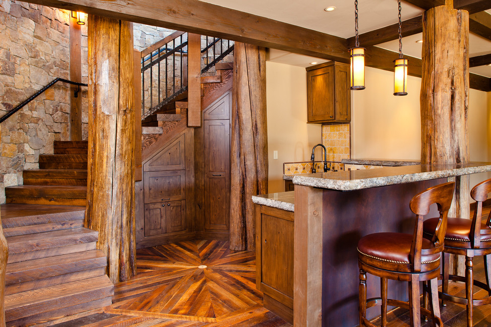 Mid-sized mountain style l-shaped dark wood floor and brown floor seated home bar photo in Denver with shaker cabinets, dark wood cabinets, granite countertops, beige backsplash and ceramic backsplash