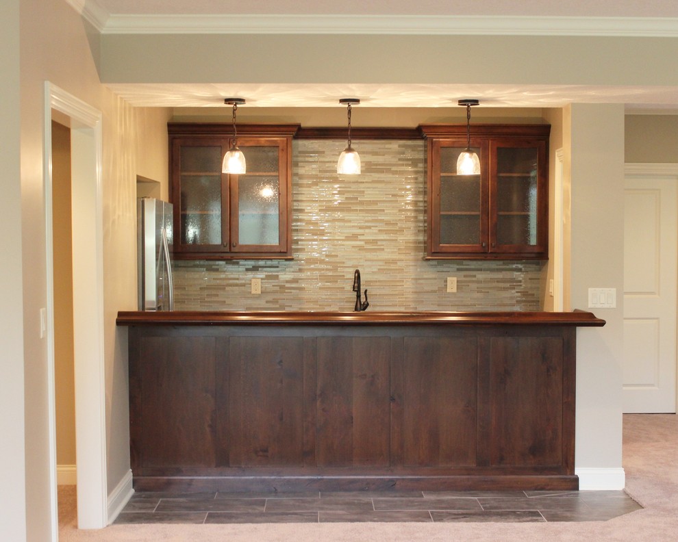 Inspiration for a small classic galley wet bar in Chicago with raised-panel cabinets, dark wood cabinets, wood worktops, multi-coloured splashback and mosaic tiled splashback.