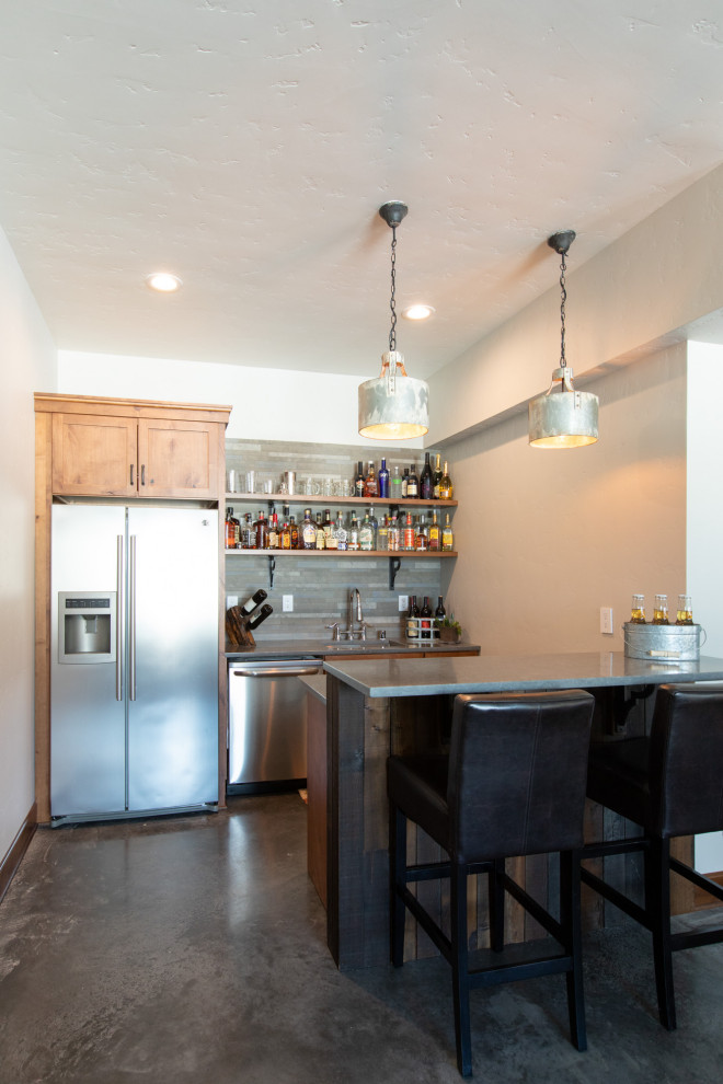 Wet bar - mid-sized cottage galley concrete floor and gray floor wet bar idea in Portland with an undermount sink, shaker cabinets, light wood cabinets, quartz countertops, gray backsplash, slate backsplash and gray countertops