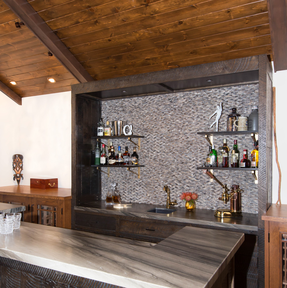 This is an example of a medium sized rustic galley wet bar in Los Angeles with a submerged sink, flat-panel cabinets, dark wood cabinets, marble worktops, brown splashback, marble splashback, medium hardwood flooring, brown floors and brown worktops.