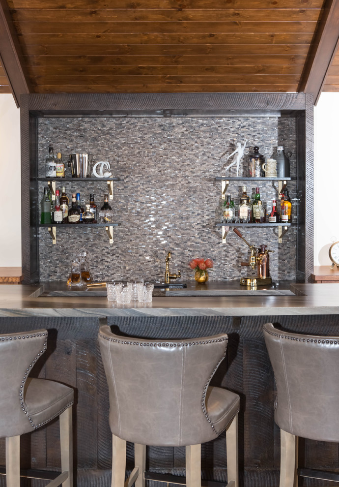 Wet bar - mid-sized rustic galley medium tone wood floor and brown floor wet bar idea in Los Angeles with an undermount sink, flat-panel cabinets, dark wood cabinets, marble countertops, brown backsplash, marble backsplash and brown countertops
