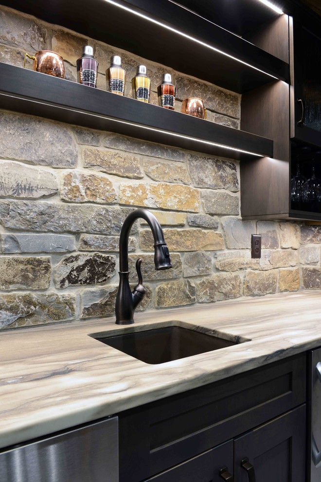 Example of a large mountain style linoleum floor seated home bar design in Other with an undermount sink, shaker cabinets, black cabinets, wood countertops, multicolored backsplash and stone tile backsplash