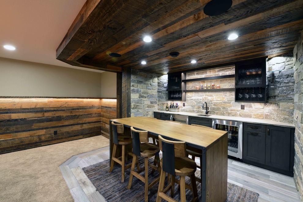 Large mountain style laminate floor seated home bar photo in Other with shaker cabinets, gray cabinets, quartzite countertops, multicolored backsplash and stone tile backsplash