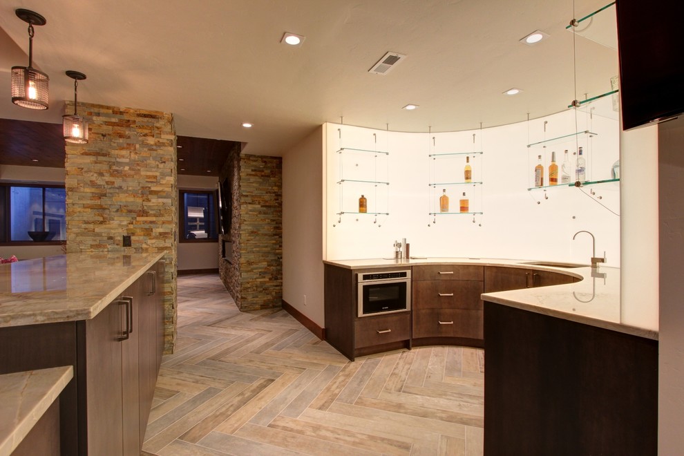 This is an example of a contemporary u-shaped wet bar in Denver with a submerged sink, flat-panel cabinets and brown cabinets.
