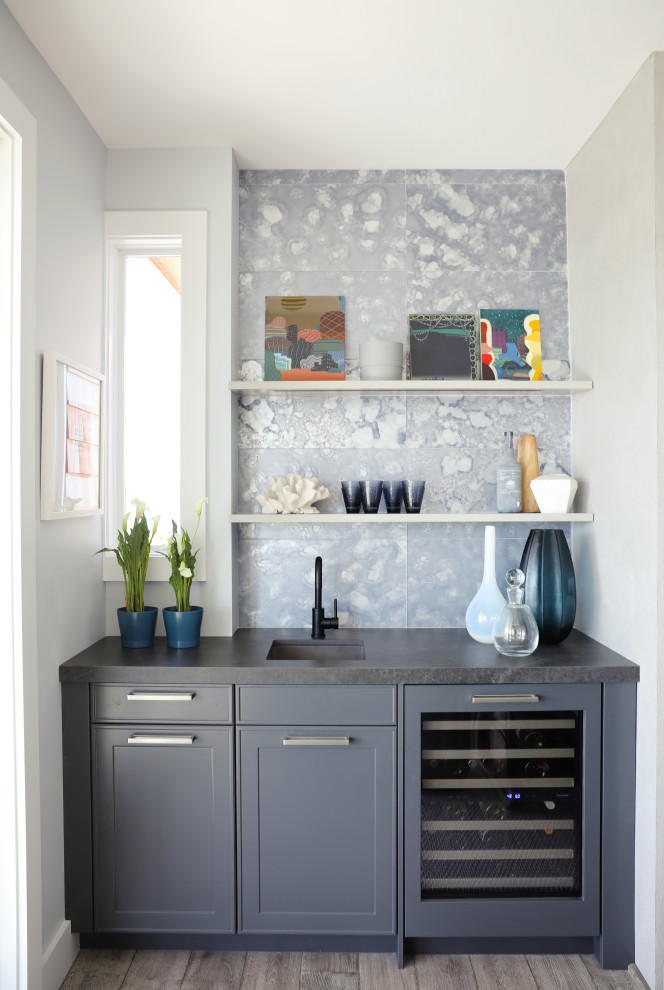 Design ideas for a large traditional single-wall wet bar in New York with a submerged sink, shaker cabinets, grey cabinets, blue splashback, porcelain splashback, grey floors, grey worktops and a feature wall.
