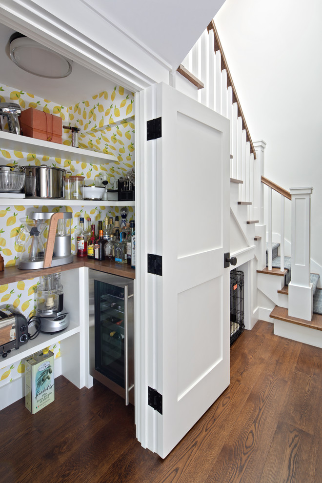 This is an example of a small midcentury home bar in San Francisco with no sink, open cabinets, white cabinets, wood worktops, medium hardwood flooring, brown floors, brown worktops and multi-coloured splashback.