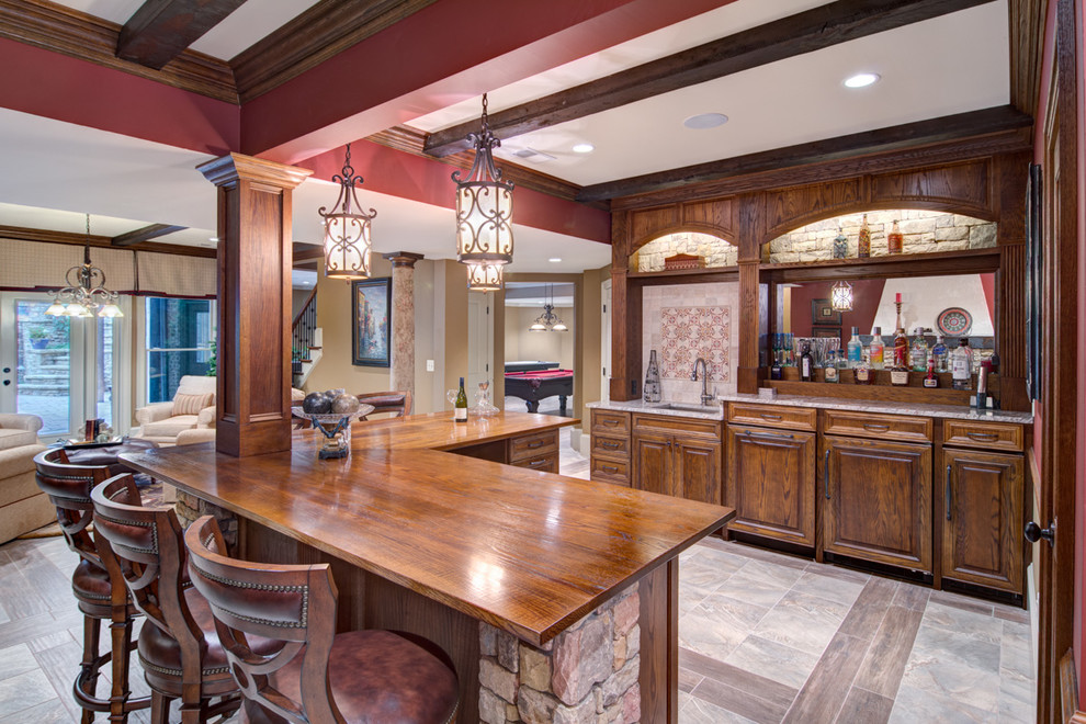 Design ideas for a large traditional l-shaped breakfast bar in Atlanta with porcelain flooring, a submerged sink, raised-panel cabinets, dark wood cabinets and mirror splashback.