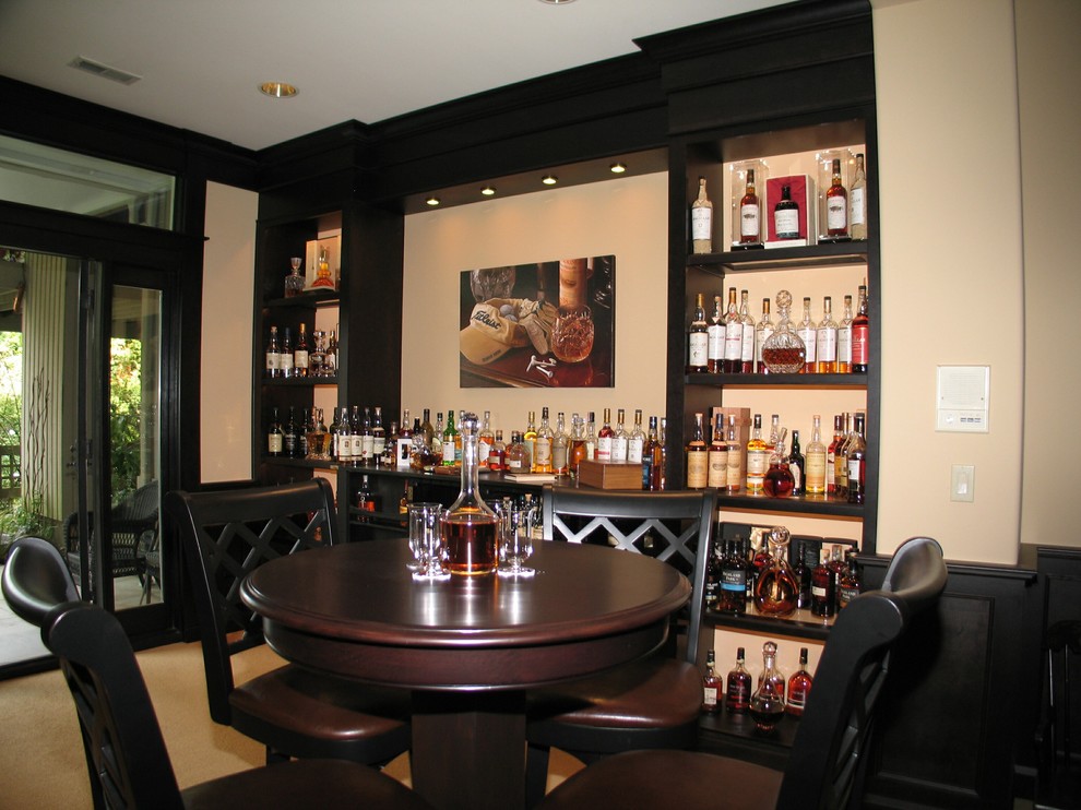 Mid-sized elegant u-shaped carpeted seated home bar photo in Seattle with an undermount sink, raised-panel cabinets, dark wood cabinets, granite countertops and mosaic tile backsplash