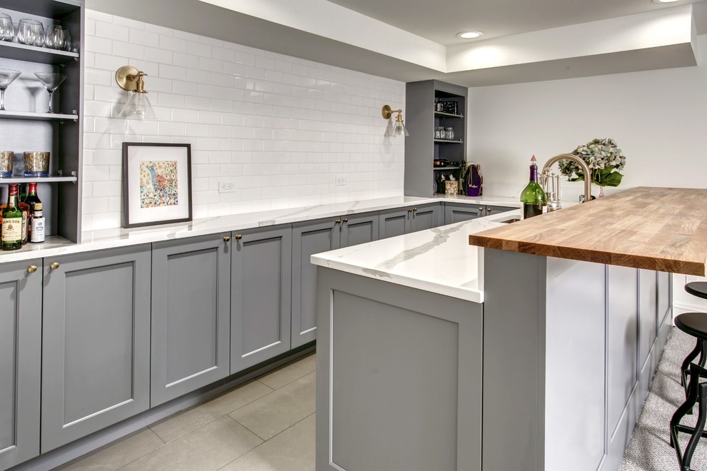 Example of a large country u-shaped porcelain tile and beige floor seated home bar design in Seattle with an undermount sink, shaker cabinets, gray cabinets, quartzite countertops, white backsplash and subway tile backsplash