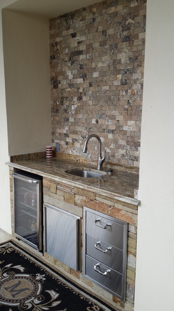 Inspiration for a large craftsman single-wall wet bar remodel in Austin with an undermount sink, granite countertops, multicolored backsplash and stone tile backsplash