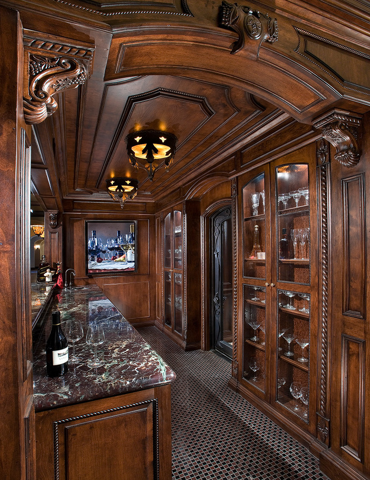 This is an example of an expansive traditional galley wet bar in Phoenix with a submerged sink, raised-panel cabinets, brown cabinets, marble worktops, marble flooring and multi-coloured floors.