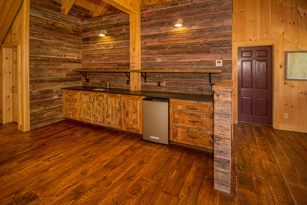 Wet bar - mid-sized rustic single-wall medium tone wood floor and brown floor wet bar idea in Other with an undermount sink, shaker cabinets, medium tone wood cabinets, solid surface countertops, brown backsplash and wood backsplash