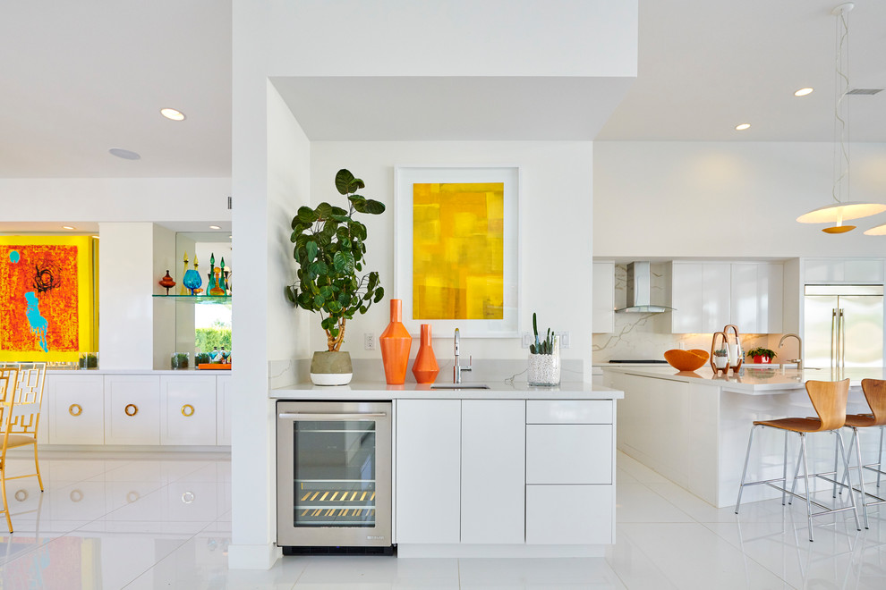 Inspiration for a small 1950s single-wall white floor wet bar remodel in Orange County with flat-panel cabinets, white cabinets, marble countertops, gray countertops and an undermount sink