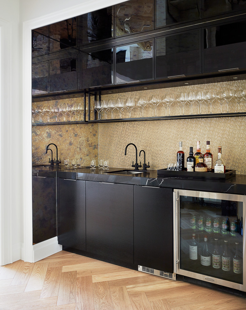 Example of a mid-sized trendy single-wall beige floor wet bar design in Toronto with an undermount sink, flat-panel cabinets, black cabinets, quartz countertops, beige backsplash and black countertops
