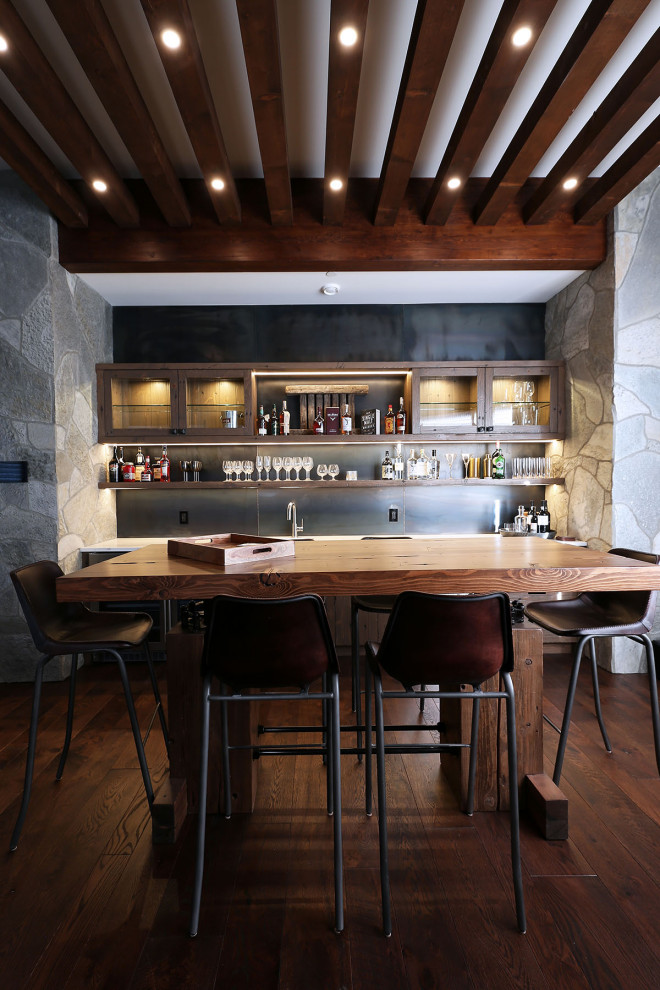 This is an example of a medium sized rustic single-wall home bar in Vancouver.
