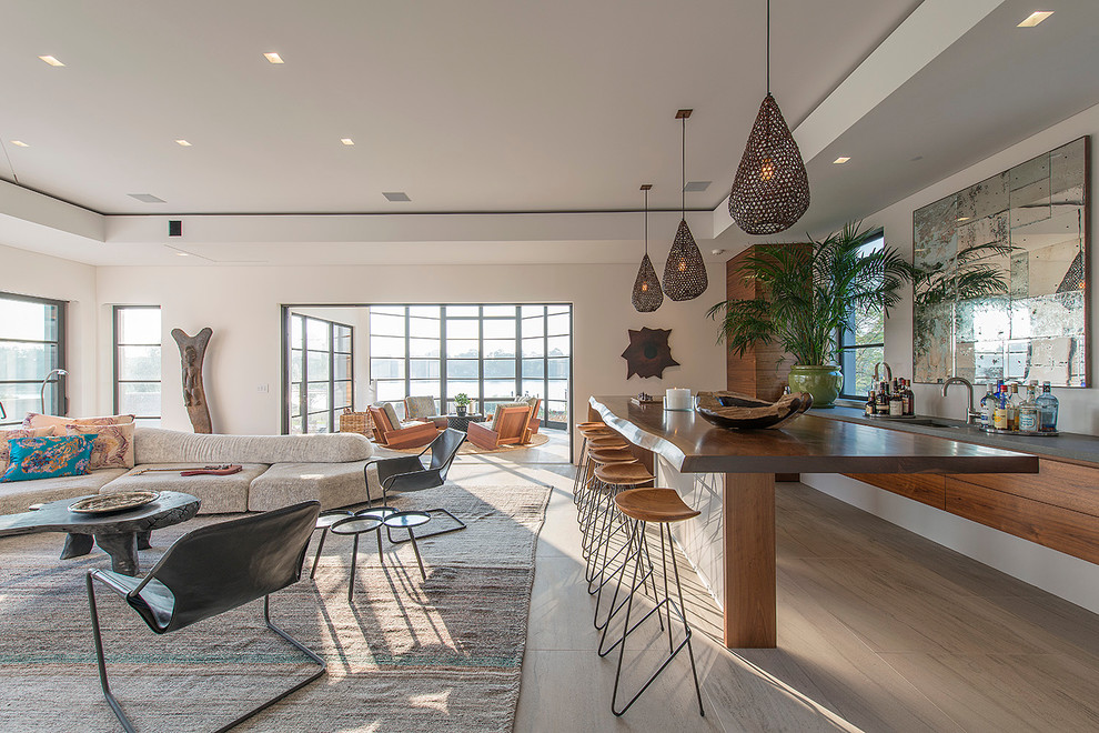 Moderne Hausbar mit Bartheke, Unterbauwaschbecken, flächenbündigen Schrankfronten, hellbraunen Holzschränken und hellem Holzboden in New York