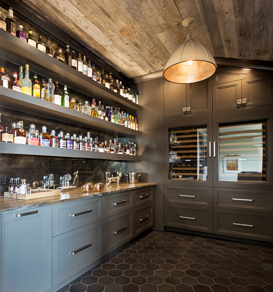 This is an example of a mid-sized transitional single-wall wet bar in Austin with an undermount sink, grey cabinets, granite benchtops, multi-coloured splashback, mirror splashback, black floor and recessed-panel cabinets.