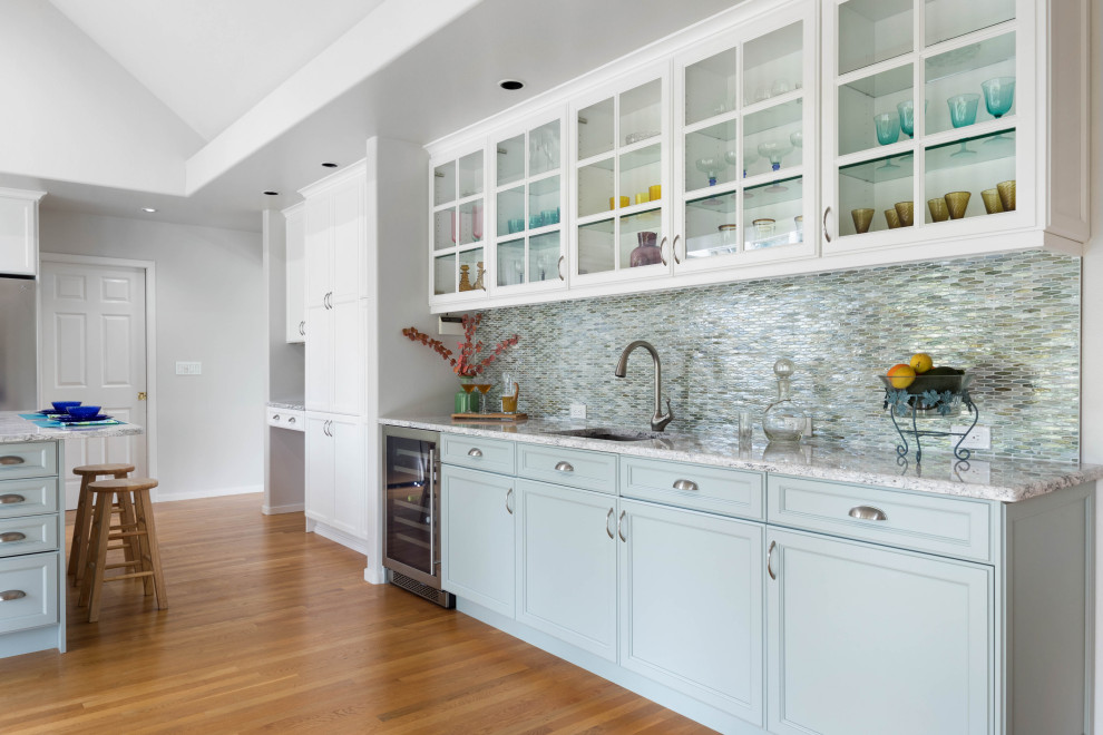 Example of a large transitional light wood floor and brown floor wet bar design in Seattle with an undermount sink, green cabinets, quartz countertops, green backsplash and glass tile backsplash