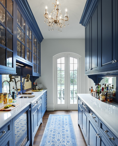 dark navy cabinets and golden chandelier in wet room