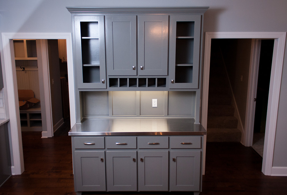 Example of a small classic single-wall dark wood floor wet bar design in Jacksonville with shaker cabinets, gray cabinets, stainless steel countertops, gray backsplash and wood backsplash