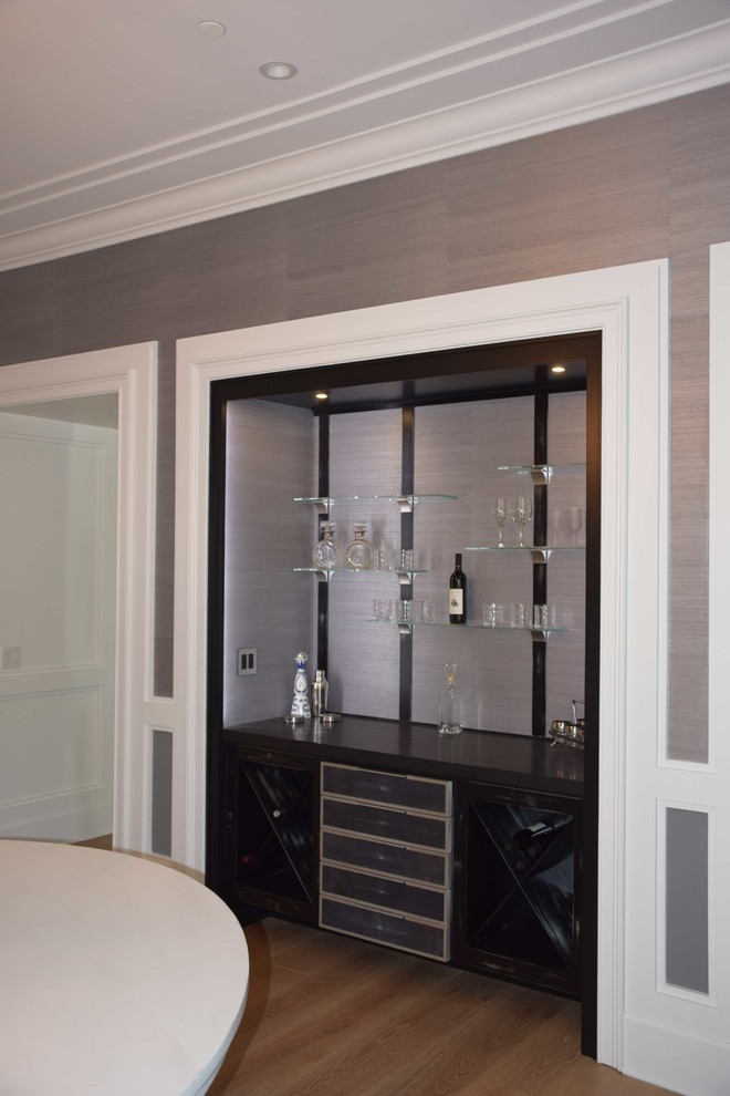 Medium sized modern single-wall home bar in Los Angeles with flat-panel cabinets, black cabinets, granite worktops and light hardwood flooring.