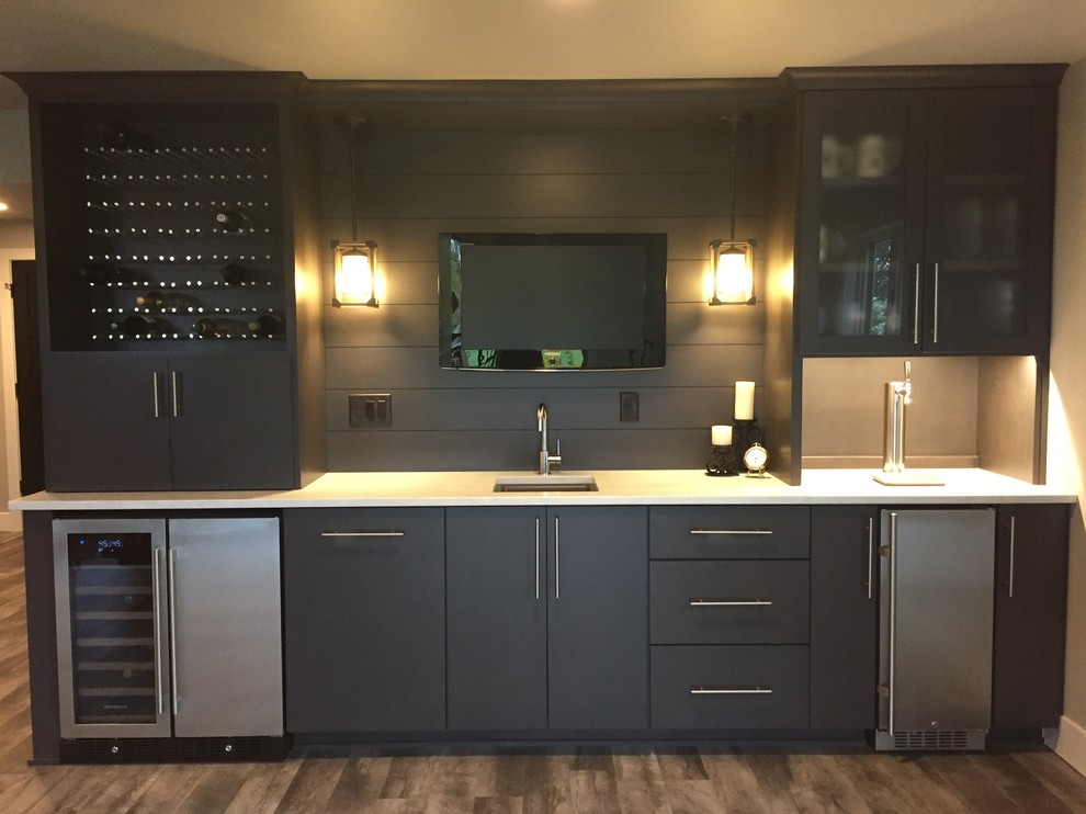 Traditional wet bar in Other with vinyl flooring, multi-coloured floors, a submerged sink, flat-panel cabinets, grey cabinets, engineered stone countertops, grey splashback and wood splashback.