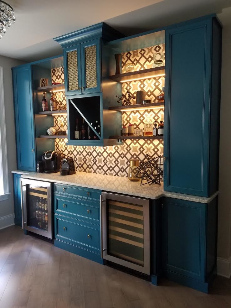 Inspiration for a traditional single-wall wet bar in San Diego with no sink, blue cabinets, ceramic splashback, light hardwood flooring and recessed-panel cabinets.
