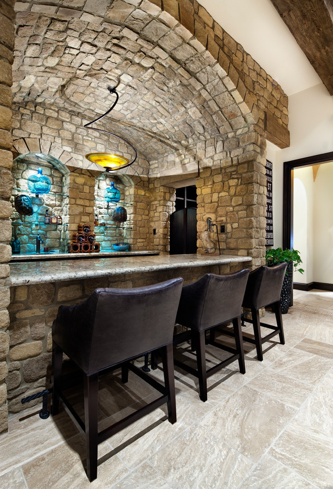 Example of a tuscan home bar design in Austin