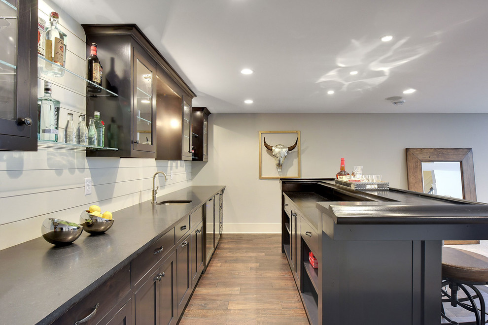 Inspiration for a large contemporary single-wall dark wood floor seated home bar remodel in Minneapolis with an undermount sink, dark wood cabinets, white backsplash and shaker cabinets