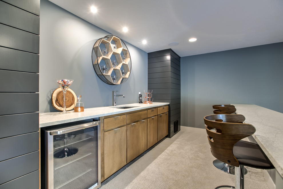 Contemporary wet bar in Omaha with a submerged sink, flat-panel cabinets and light wood cabinets.
