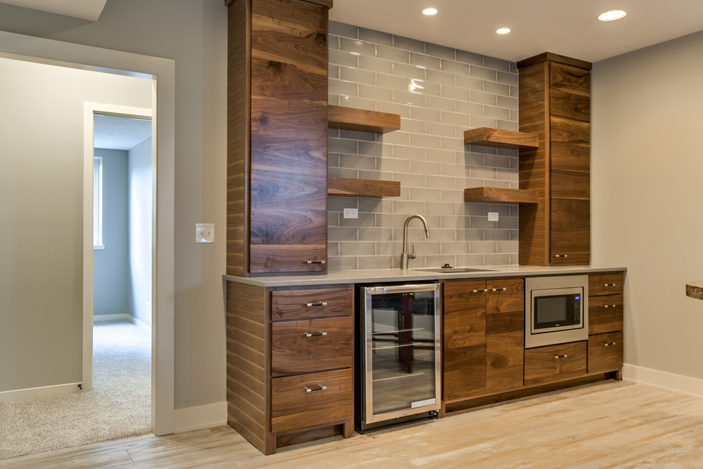 Photo of a large contemporary single-wall wet bar in Other with a submerged sink, flat-panel cabinets, dark wood cabinets, quartz worktops, grey splashback, ceramic splashback, ceramic flooring and beige floors.