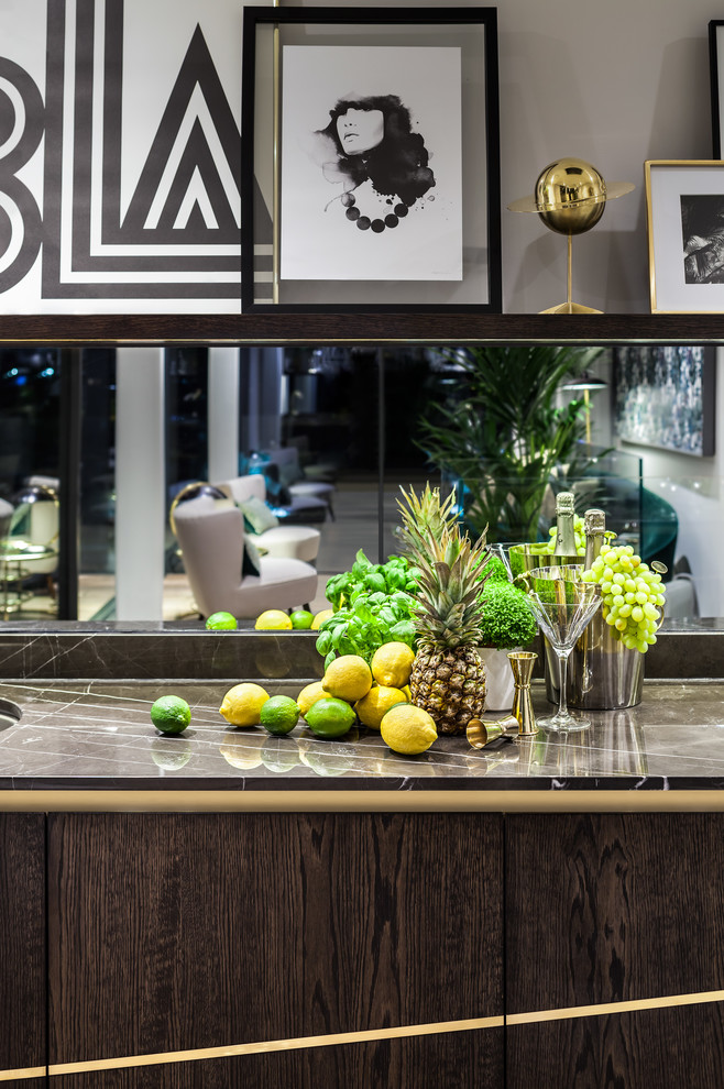 Medium sized contemporary single-wall home bar in London with flat-panel cabinets, dark wood cabinets, marble worktops, mirror splashback, light hardwood flooring and beige floors.
