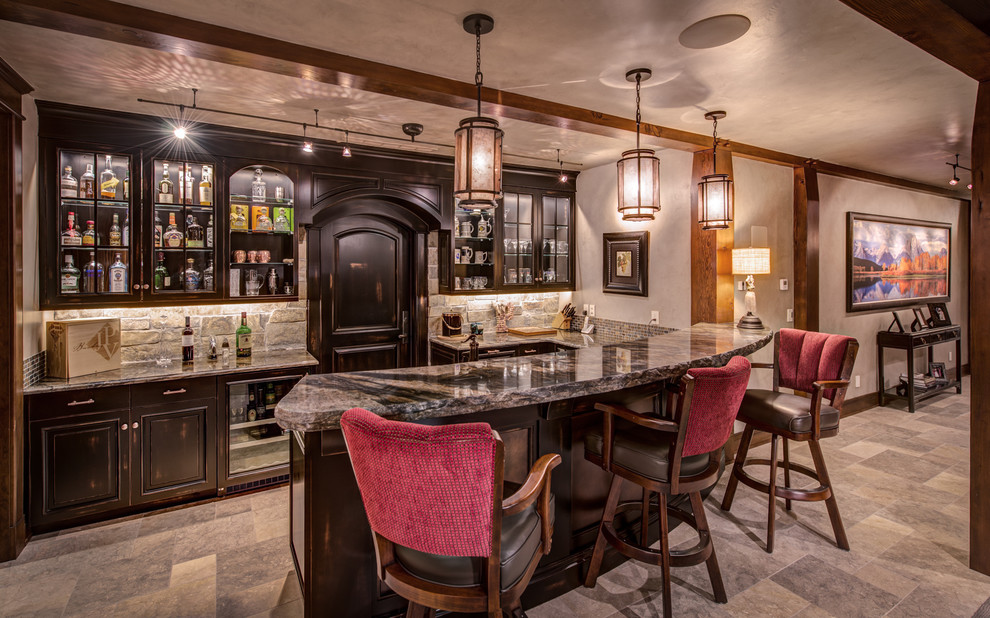 This is an example of a rustic u-shaped breakfast bar in Denver with raised-panel cabinets, dark wood cabinets, grey splashback and beige floors.