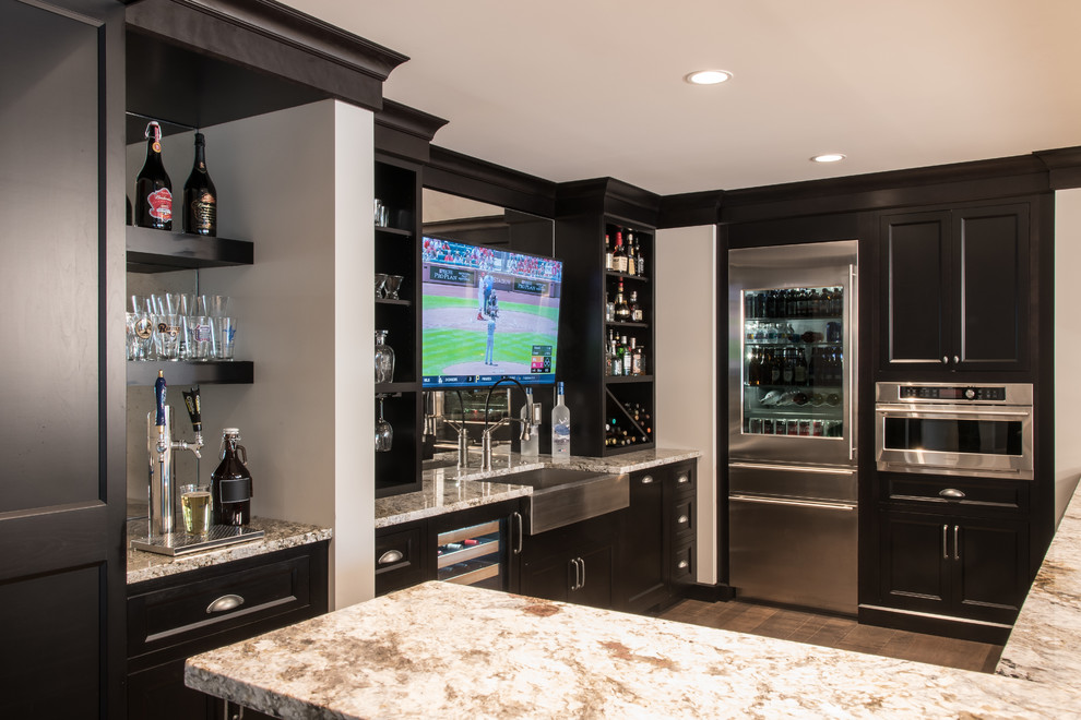 Design ideas for a classic u-shaped wet bar in St Louis with brown floors, a submerged sink, shaker cabinets, black cabinets, mirror splashback and beige worktops.