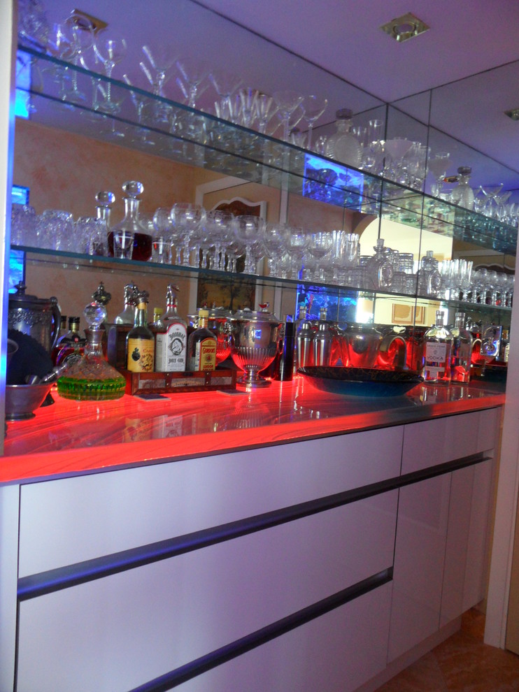 Large modern single-wall home bar in Miami with flat-panel cabinets, white cabinets and mirror splashback.