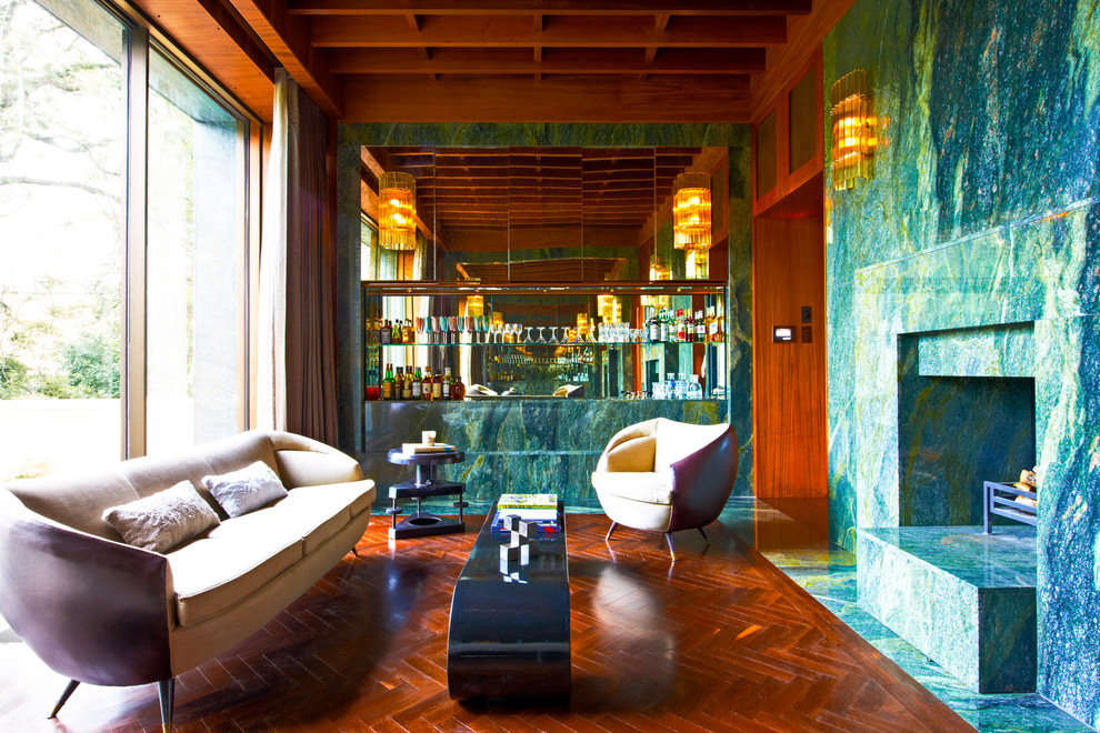 Medium sized contemporary galley home bar in London with medium hardwood flooring.