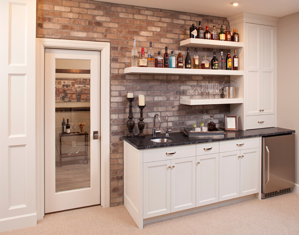 Inspiration for a timeless single-wall carpeted and beige floor wet bar remodel in Minneapolis with an undermount sink, recessed-panel cabinets and white cabinets