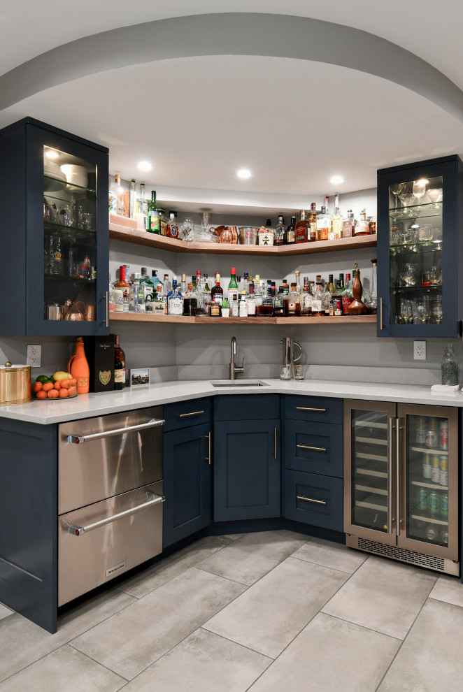 Large classic home bar with porcelain flooring and grey floors.