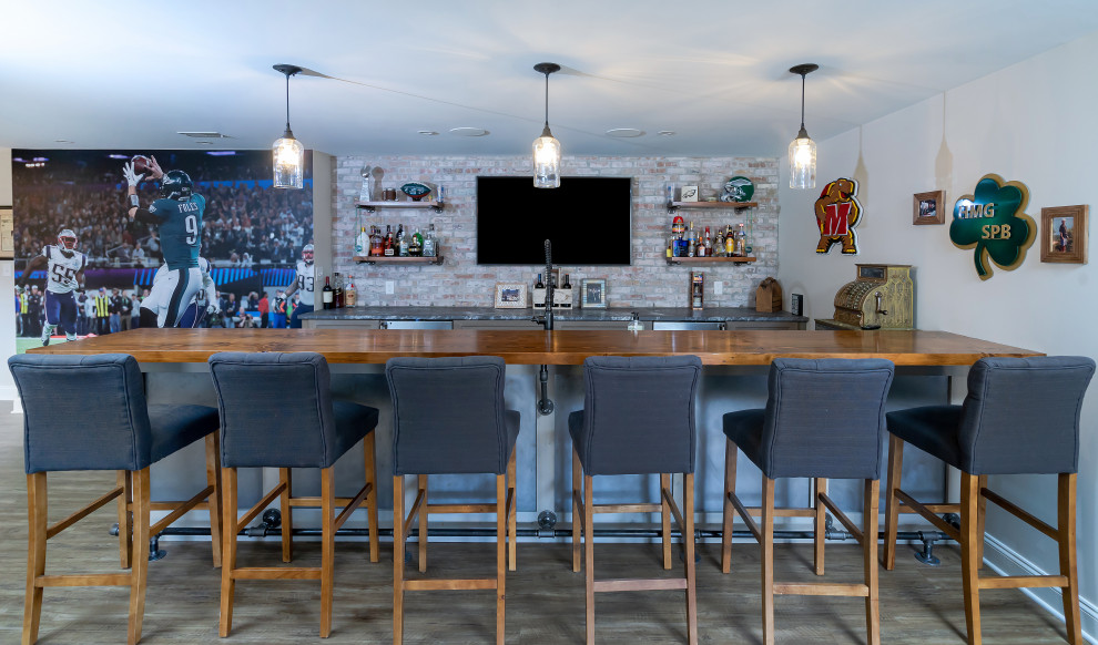 This is an example of a classic galley breakfast bar in Philadelphia with flat-panel cabinets, wood worktops, multi-coloured splashback, brick splashback, medium hardwood flooring, brown floors and brown worktops.