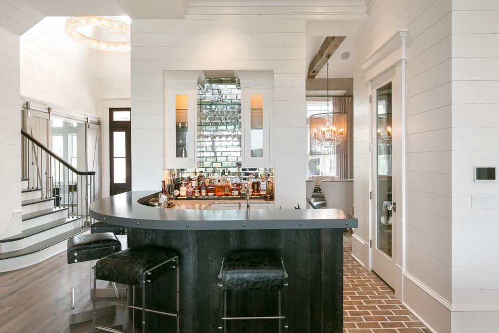 Design ideas for a classic u-shaped wet bar in Charleston with white cabinets, glass tiled splashback, medium hardwood flooring and brown floors.